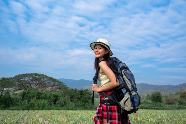 hipster-young-girl-with-backpack-enjoying-beautiful-bluesky-nature